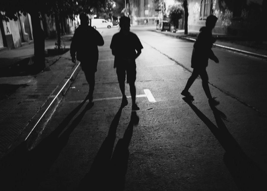 3 guys walking down a dark street